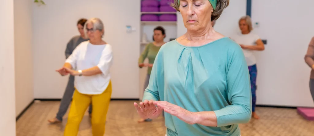 A group of women taking a Tai Chi class.